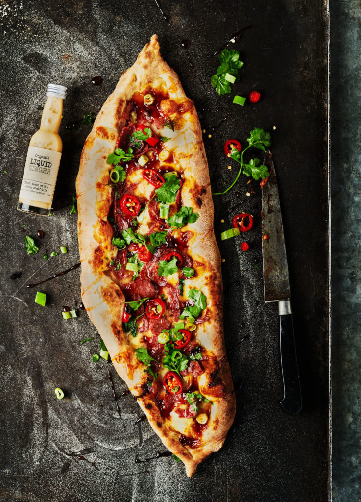 Food and drink photography capturing crispy duck pizza, produced in a Sussex studio for editorial and brand use