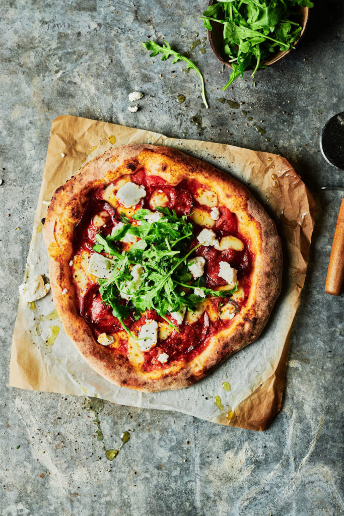Creative food and drink photography of rustic pizza with crust, styled and photographed in Sussex by a commercial London food photographer Rob Morris