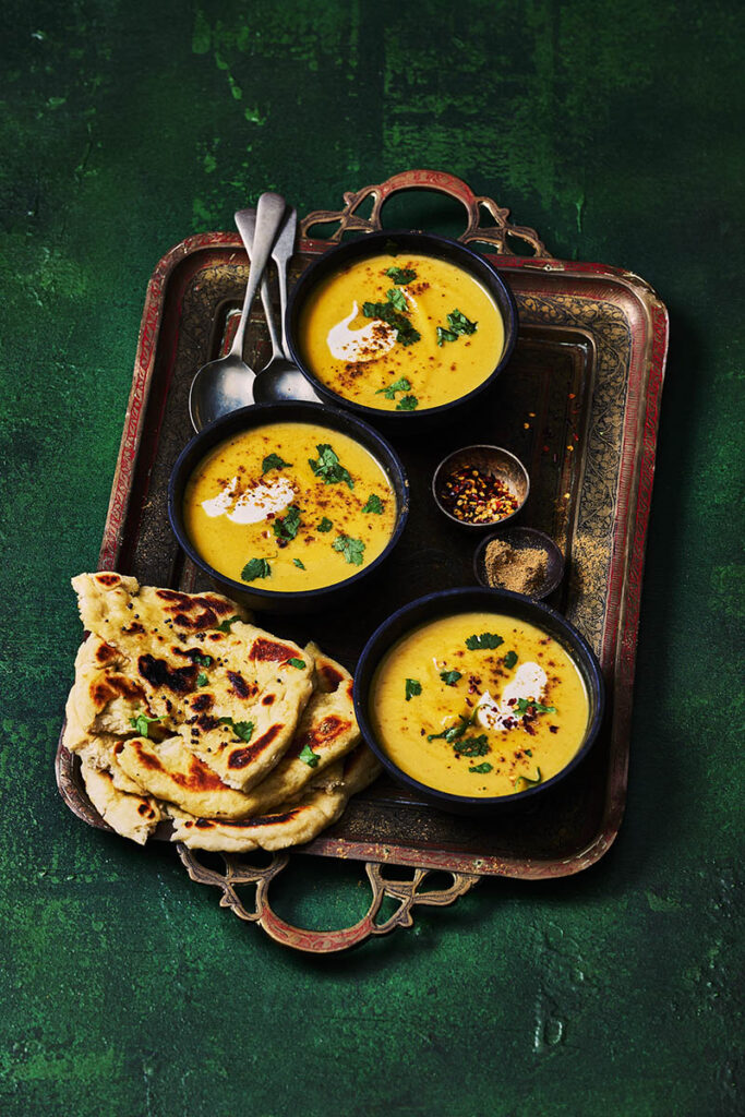Silky smooth pumpkin soup in a rustic bowl, styled by East Sussex food photographer & Stylist.