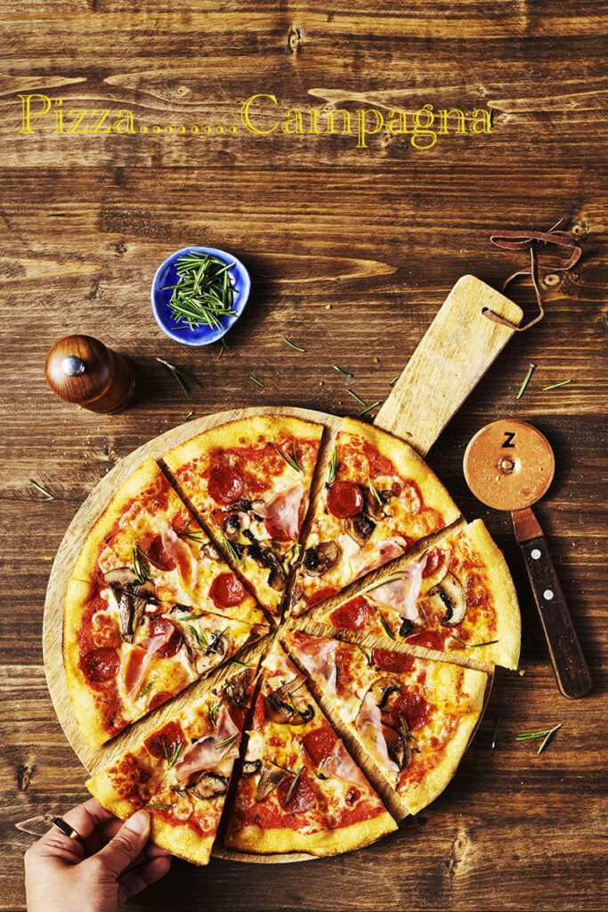 Food and drink photography of Pizza, with hand, photographed in Sussex by a food photographer working with London clients