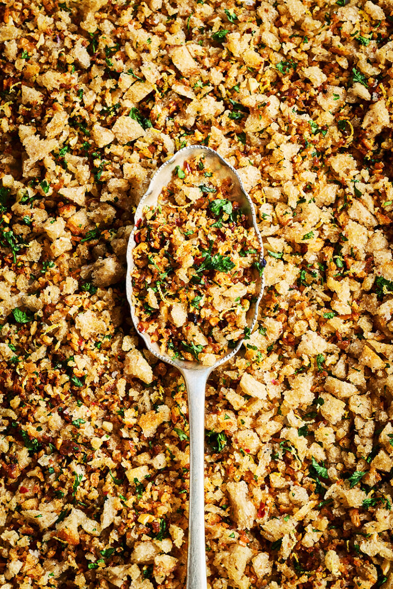 Pangratatto crumb, shot macro filling the whole frame, very graphic with a spoon in the center of frame.